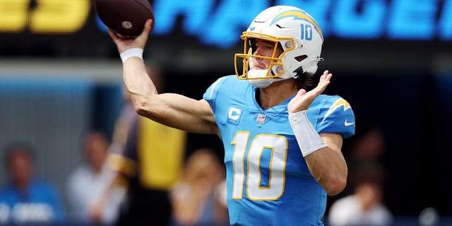 Quarterback Justin Herbert #10 of the Los Angeles Chargers attempts a pass during the first half against the Las Vegas Raiders at SoFi Stadium on September 11, 2022 in Inglewood, California.