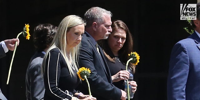 Slain Louisiana State University student Allison Rice's parents, Paul Rice (middle) and Angela Engler (left) leaving their daughter's funeral Wednesday, September 21, 2022, at St. John the Evangelist in Prairieville, Louisiana.