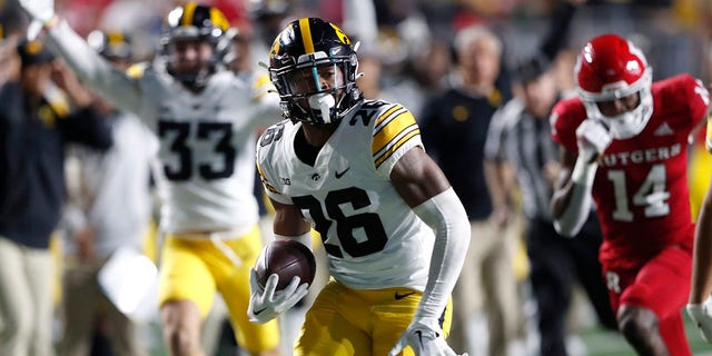 Iowa defensive back Kaevon Merriweather (26) returns a fumble for a touchdown against Rutgers during the first half of a game, Saturday, Sept. 24, 2022, in Piscataway, N.J.