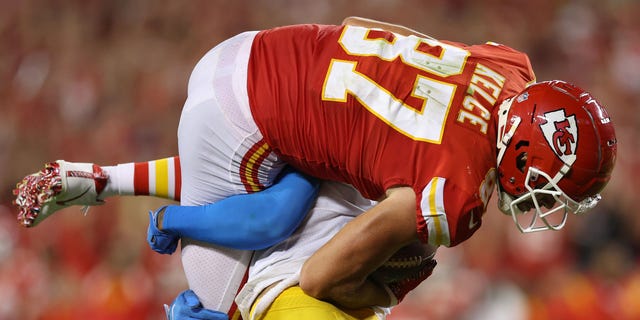 Derwin James Jr. of the Los Angeles Chargers lifts and slams Travis Kelce of the Kansas City Chiefs during the third quarter at Arrowhead Stadium in Kansas City on Sept. 15, 2022.