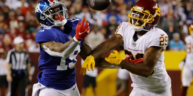 New York Giants wide receiver Kenny Golladay, #19, attempts to make a catch as Washington Football Team cornerback Kendall Fuller, #29, defends in the third quarter at FedExField in Landover, Maryland, Sept. 16, 2021.