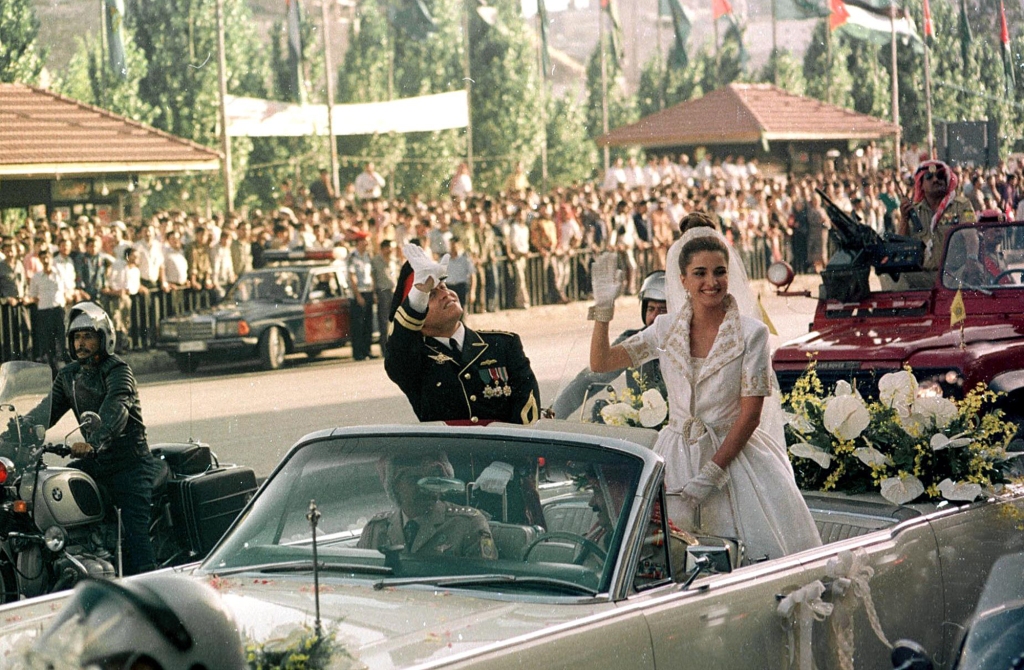 King Abdullah and Queen Rania drive through the streets of Amman on their wedding day in June 1993 — mere months after meeting at a dinner party.