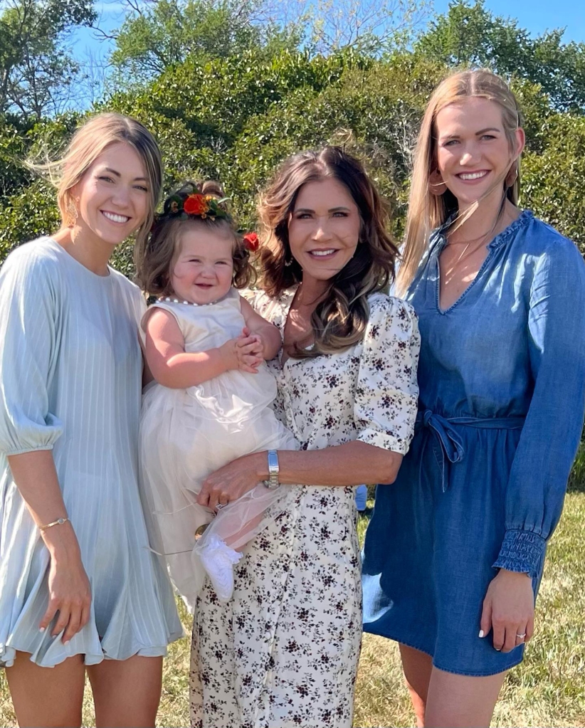 Noem holding granddaughter Adeline flanked by daughters Kennedy (left) and Kassidy (right). 