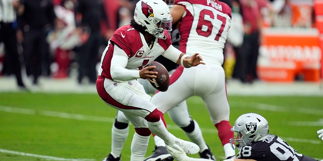 Arizona Cardinals quarterback Kyler Murray, left, is tackled by Las Vegas Raiders defensive end Maxx Crosby (98) during the first half in Las Vegas on Sept. 18, 2022.