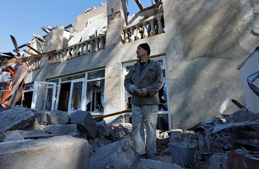 A man removes debris of a building destroyed by recent shelling during the Russia-Ukraine conflict in the city of Kadiivka, Ukraine.