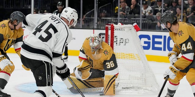 Vegas Golden Knights goaltender Logan Thompson (36) blocks a shot by Los Angeles Kings' Jacob Doty (45) during the first period of an NHL preseason hockey game Monday, Sept. 26, 2022, in Las Vegas.