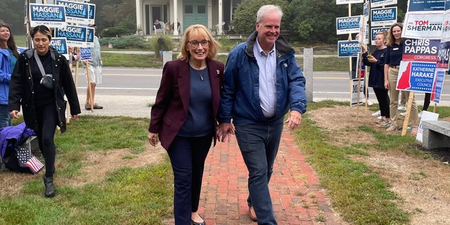 Sen. Maggie Hassan, D-N.H., and her husband, Tom Hassan, arrive to vote on primary day in Newfields, New Hampshire, on Tuesday.