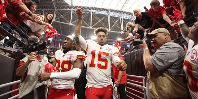 Cornerback L'Jarius Sneed #38 and quarterback Patrick Mahomes #15 of the Kansas City Chiefs walk off the field after the game against the Arizona Cardinals at State Farm Stadium on September 11, 2022 in Glendale, Arizona. The Chiefs won 44-21.