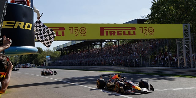 Red Bull driver Max Verstappen crosses the finish line to win the Italian Grand Prix, Sunday, Sept. 11, 2022.