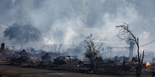 A view of a burnt car and other burnt structures as the Mill Fire burns near Weed, California, U.S., September 2, 2022. 