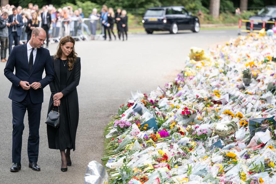 Prince William and Kate Middleton survey the tributes left for the Queen.