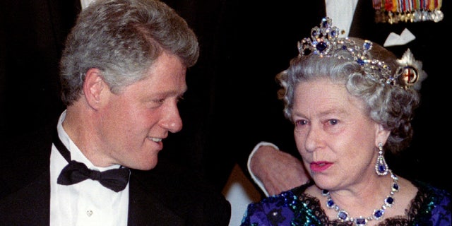 US President Bill Clinton speaks with Queen Elizabeth II of England during the official group photo before a dinner at the Guildhall June 4. World leaders headed D-Day commemorations here. (REUTERS/Kevin Coombs)