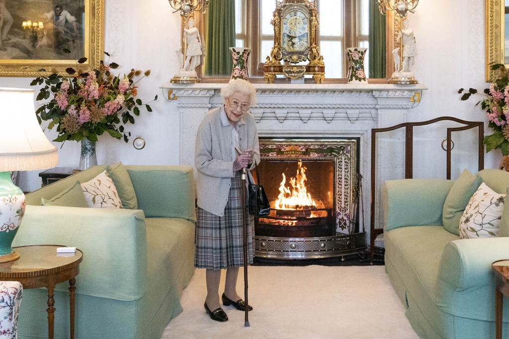 Queen Elizabeth II is seen holding a cane as she prepares to meet with Truss at Balmoral Castle. 