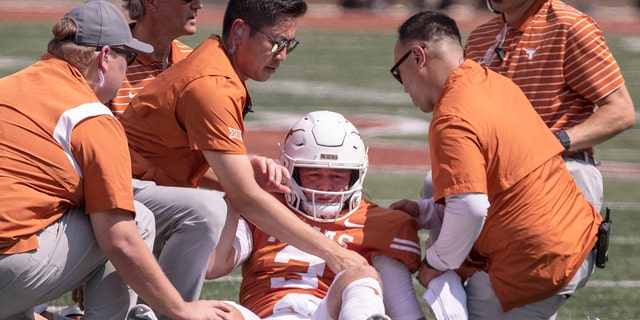 Texas quarterback Quinn Ewers, #3, is helped up off the ground after a hit and personal foul by Alabama linebacker Dallas Turner during the first half of an NCAA college football game, Saturday, Sept. 10, 2022, in Austin, Texas.