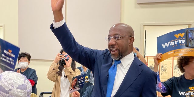 Democratic Sen. Raphael Warnock of Georgia greets supporters as he arrives at a Korea senior center in Norcross, Georgia, on Sept. 27, 2022