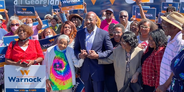 Democratic Sen. Raphael Warnock, of Georgia, with supporters at a rally for seniors in Atlanta on Sept. 26, 2022