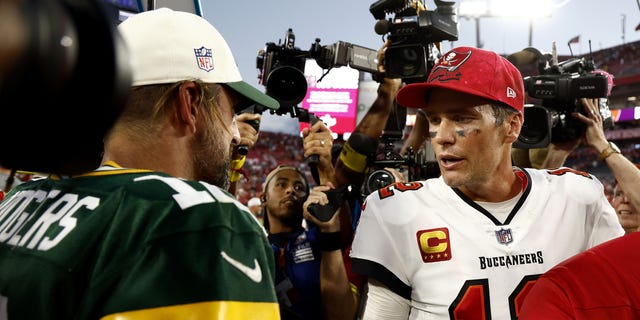 Aaron Rodgers of the Green Bay Packers, left, talks with Tom Brady of the Tampa Bay Buccaneers after the game at Raymond James Stadium in Tampa, Florida, on Sept. 25, 2022.