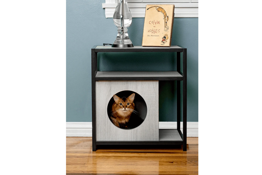 A side table with a cat hole and a cat inside 