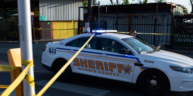 A Houston police officer moves a vehicle from a crime scene in Houston May 15, 2022.