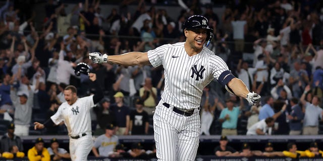 Giancarlo Stanton #27 of the New York Yankees celebrates as he hits a walk-off grand-slam home run to end the game during the 9th inning of the game against the Pittsburgh Pirates at Yankee Stadium on September 20, 2022, in the Bronx borough of New York City. The Yankees defeated the Pirates with a final score of 9-8 to win the game.