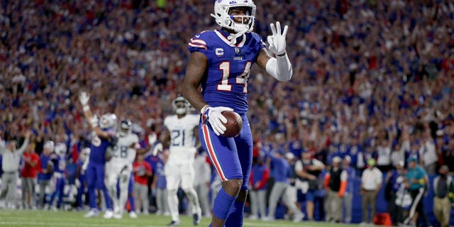 Stefon Diggs #14 of the Buffalo Bills celebrates after scoring his third touchdown of the night against the Tennessee Titans during the third quarter of the game at Highmark Stadium on September 19, 2022 in Orchard Park, New York.