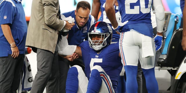 Trainers lift Kayvon Thibodeaux (5) of the New York Giants off the field after he suffered an injury during the first half of a preseason game against the Cincinnati Bengals at MetLife Stadium Aug. 21, 2022, in East Rutherford, N.J.