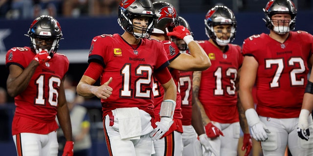 Tampa Bay Buccaneers quarterback Tom Brady signals to the sideline during the Dallas Cowboys game in Arlington, Texas, Sunday, Sept. 11, 2022.