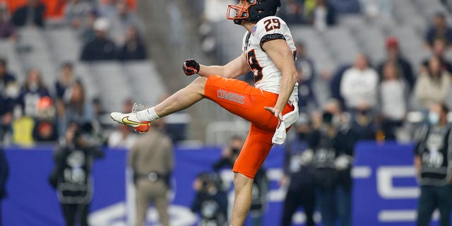 Oklahoma State punter Tom Hutton punts during the PlayStation Fiesta Bowl against the Notre Dame Fighting Irish Jan. 1, 2022, at State Farm Stadium in Glendale, Ariz.