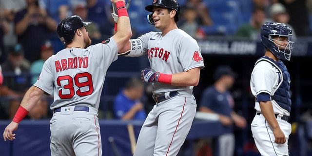 Boston Red Sox's Triston Casas, center, is congratulated by Christian Arroyo on his two-run home run, next to Tampa Bay Rays catcher Francisco Mejia during the second inning of a baseball game Tuesday, Sept. 6, 2022, in St. Petersburg, Florida.