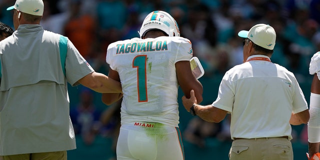 Miami Dolphins quarterback Tua Tagovailoa is helped off the field during the first half of a game against the Buffalo Bills Sunday, Sept. 25, 2022, in Miami Gardens.