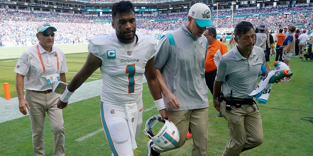 Miami Dolphins quarterback Tua Tagovailoa (1) is assisted off the field after he was injured during the first half of an NFL football game against the Buffalo Bills, Sunday, Sept. 25, 2022, in Miami Gardens, Fla.