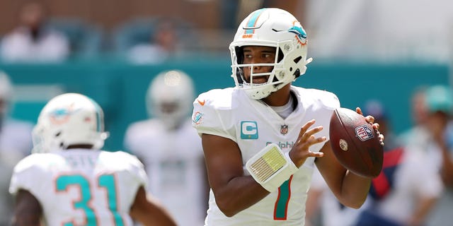 Quarterback Tua Tagovailoa #1 of the Miami Dolphins lays on the turf during the first half of the game against the Buffalo Bills at Hard Rock Stadium on Sept. 25, 2022 in Miami Gardens, Florida.