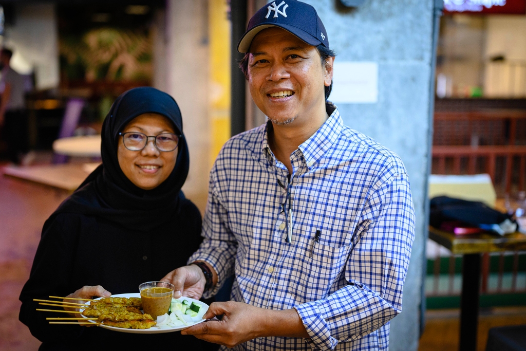 Husband and wife team of owners Sulaiman Rahman and Annie Ahmad with chicken satay from their stand Padi at Urban Hawker market.