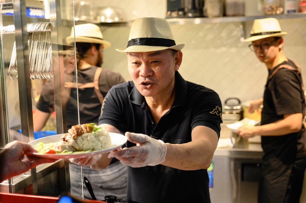 Raymond Kiang with the signature chicken rice dish from Hainan Jones, an Urban Hawker vendor hailing from Singapore.
