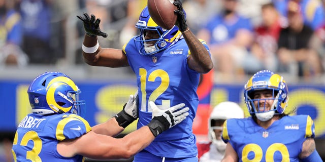 Van Jefferson of the Los Angeles Rams jumps into the arms of Austin Corbett to celebrate his first quarter touchdown against the Arizona Cardinals at SoFi Stadium in Inglewood, California, on Oct. 3, 2021.