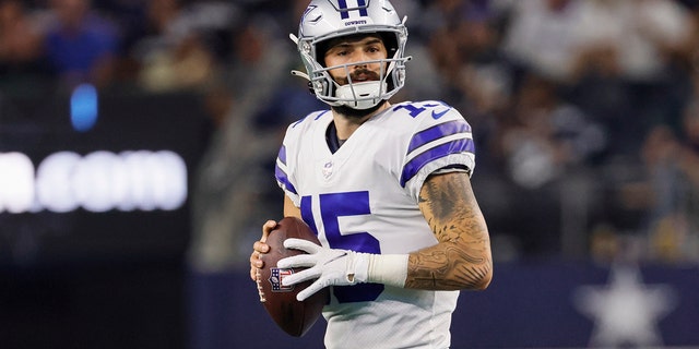 Dallas Cowboys quarterback Will Grier, #15, looks downfield for an open receiver during the game between the Dallas Cowboys and the Seattle Seahawks on Aug. 26, 2022 at AT&amp;T Stadium in Arlington, Texas.