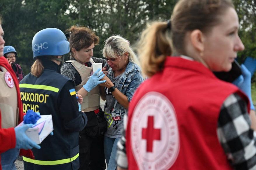 First responders help a person who was involved in the Russian missile strike in Zaporizhzhia, Ukraine on Sept. 30, 2022.