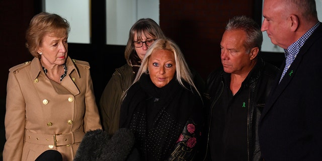 Business Secretary Andrea Leadsom, left, Harry Dunn's mother Charlotte Charles, center, and his stepfather Bruce Charles, second right, and family spokesperson Radd Seiger, right, outside South Northamptonshire Council offices in Towcester, after they met following the news that the US have refused to extradite Anne Sacoolas. 