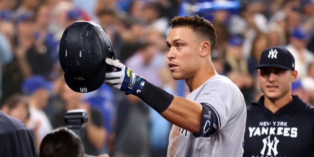 Aaron Judge #99 of the New York Yankees tips his hat towards his mother after hitting his 61st home run of the season in the seventh inning against the Toronto Blue Jays at Rogers Centre on September 28, 2022 in Toronto, Ontario, Canada. Judge has now tied Roger Maris for the American League record. 