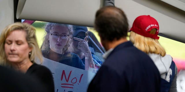 Abortion opponents are seen outside as the Michigan Board of State Canvassers meet during a hearing, Wednesday, Aug. 31, 2022, in Lansing, Mich.