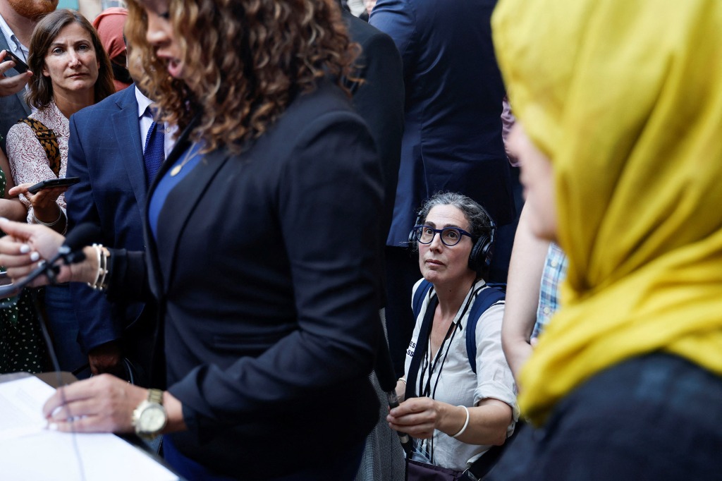 Podcaster Sarah Koenig records outside the court hearing.