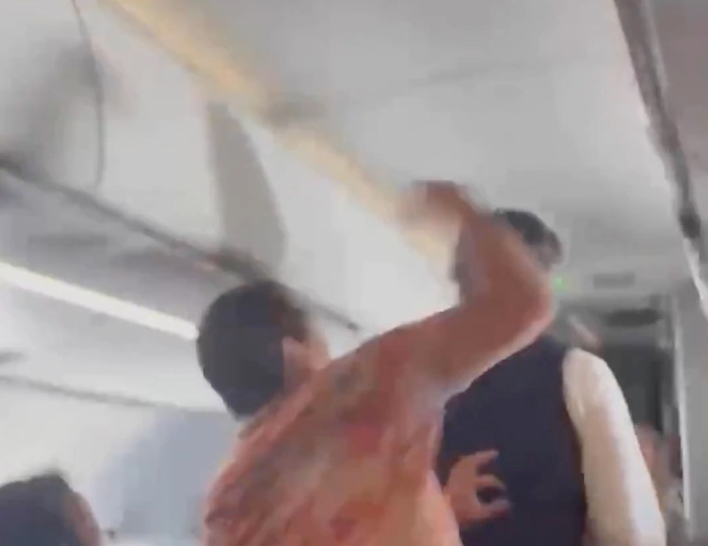 Video shows the passenger punching the attendant in the back of the head after the airline employee asked the man if he was threatening him. 