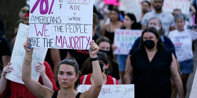 Protesters march around the Arizona Capitol in Phoenix after the Supreme Court decision to overturn Roe v. Wade, Friday, June 24, 2022. A new Arizona law banning abortions after 15 weeks of pregnancy takes effect Saturday, Sept. 24, 2022 as a judge weighs a request to allow a pre-statehood law that outlaws nearly all abortions to be enforced.