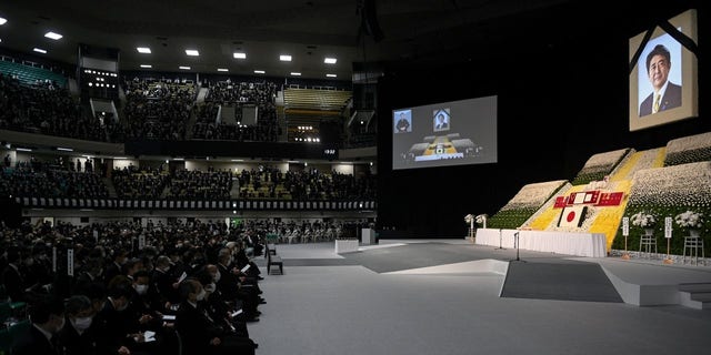 Guests wait for the start of the state funeral of former Japanese Prime Minister Shinzo Abe at the Nippon Budokan in Tokyo on September 27, 2022. 