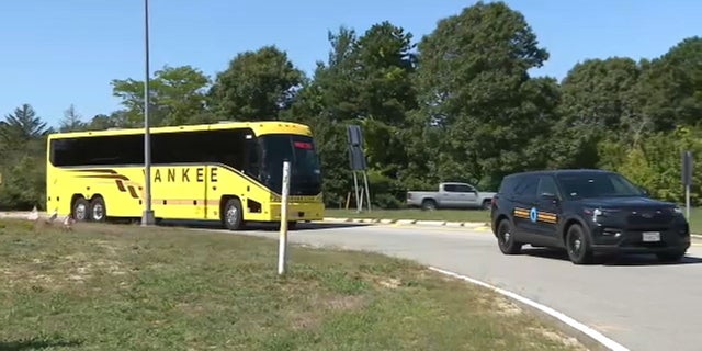 A bus carrying migrants sent to Martha's Vineyard arrives at Joint Base Cape Cod in Massachusetts, Friday, Sept. 16, 2022.