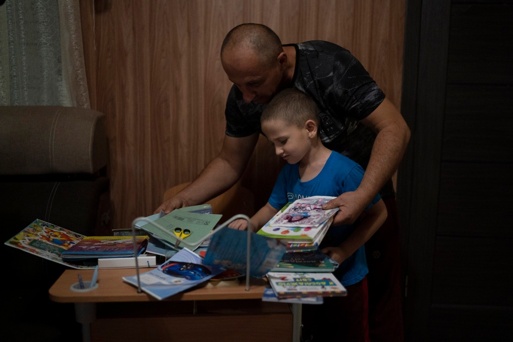 Oleksii Makarov, 6, displays his books and scholar materials on his student desk, that he uses for online classes.