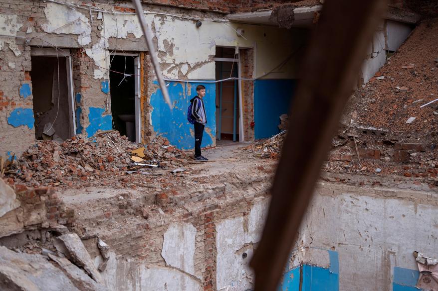 Mykola Kravchenko, 12, looks at his computer class destroyed.