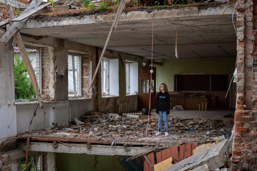 Anna Skiban, 12, stands in the rubble of her former classroom.