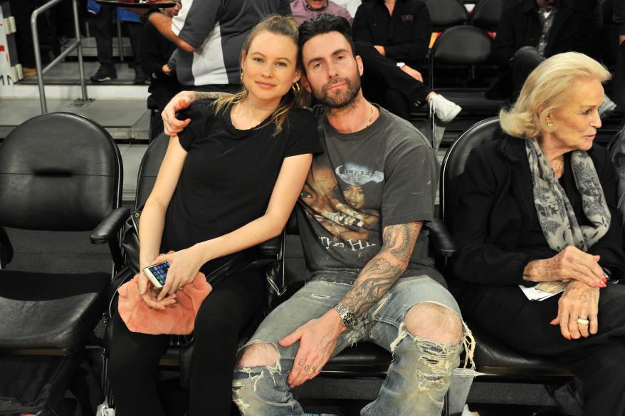 Model Behati Prinsloo and singer Adam Levine attend a basketball game between the Los Angeles Lakers and the Philadelphia 76ers at Staples Center on November 15, 2017 in Los Angeles, California.