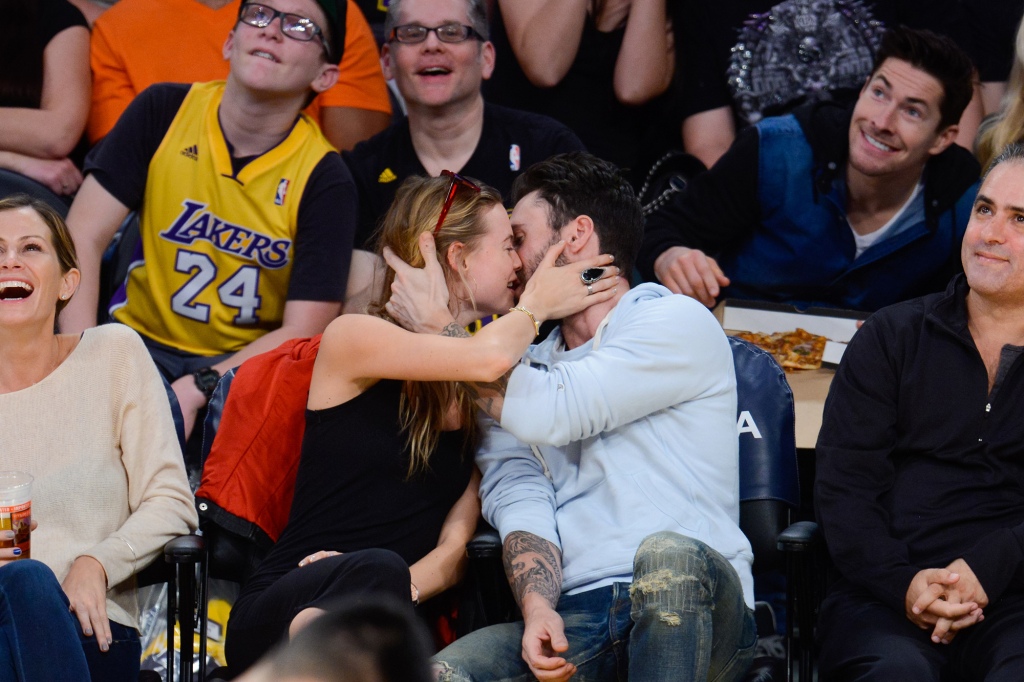 The lovers often packed on the PDA, seen here smooching at an NBA game in 2014. 